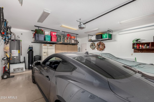 garage with a garage door opener and water heater