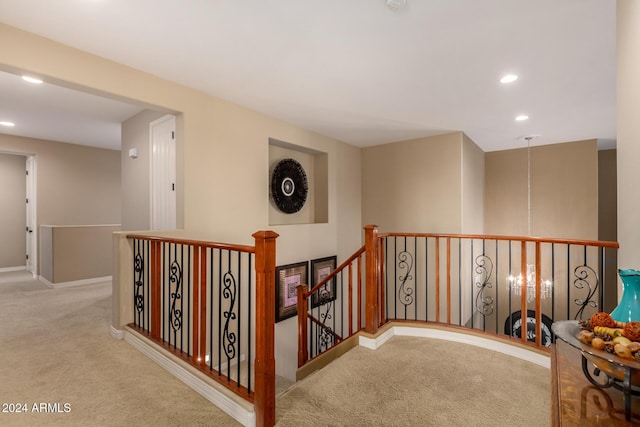 corridor featuring light colored carpet