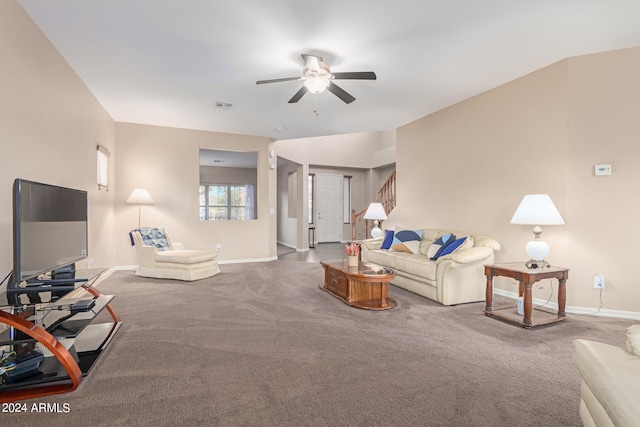 living room with ceiling fan and carpet