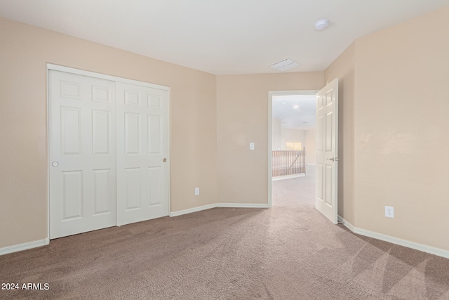 unfurnished bedroom featuring a closet and carpet