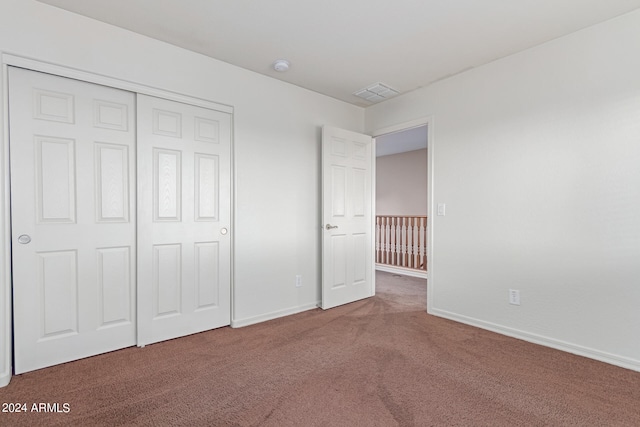 unfurnished bedroom with a closet and carpet