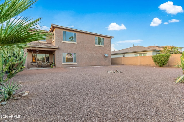 back of house with a patio