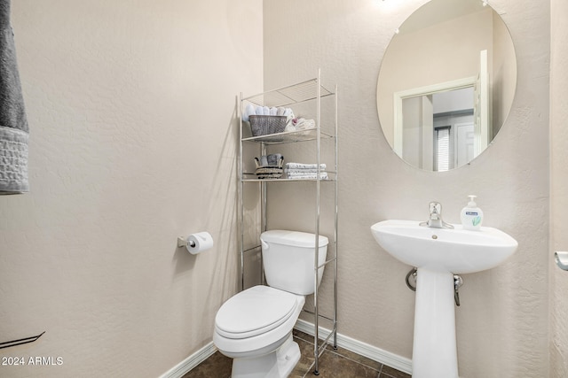 bathroom featuring tile patterned flooring and toilet