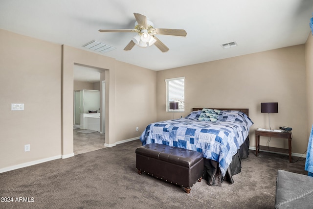 bedroom with ceiling fan, connected bathroom, and dark carpet