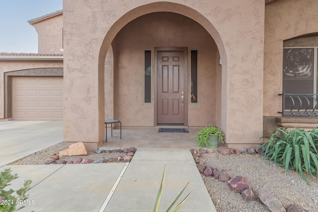 view of exterior entry featuring a garage