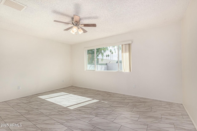 unfurnished room with a textured ceiling and ceiling fan