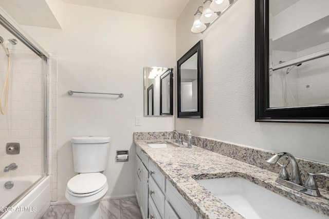 full bathroom featuring enclosed tub / shower combo, vanity, and toilet