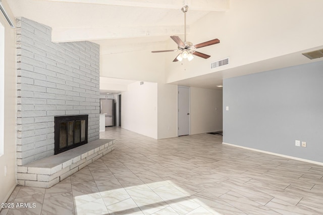 unfurnished living room with beamed ceiling, ceiling fan, high vaulted ceiling, and a fireplace