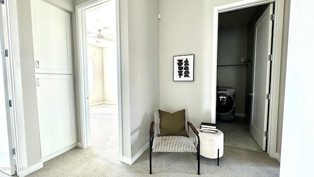 corridor featuring carpet floors, washer / dryer, and baseboards