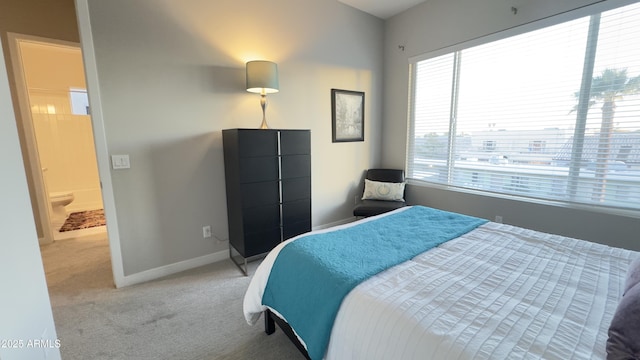 bedroom featuring baseboards and light colored carpet