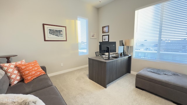 office space featuring baseboards and light colored carpet