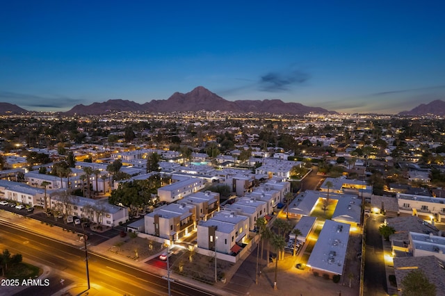 aerial view at dusk featuring a mountain view