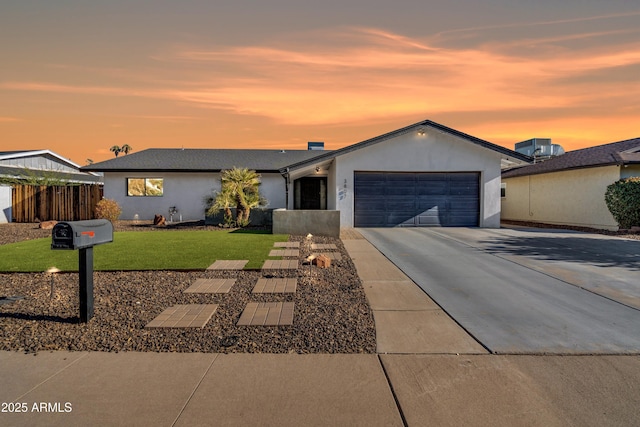 ranch-style home featuring a yard and a garage