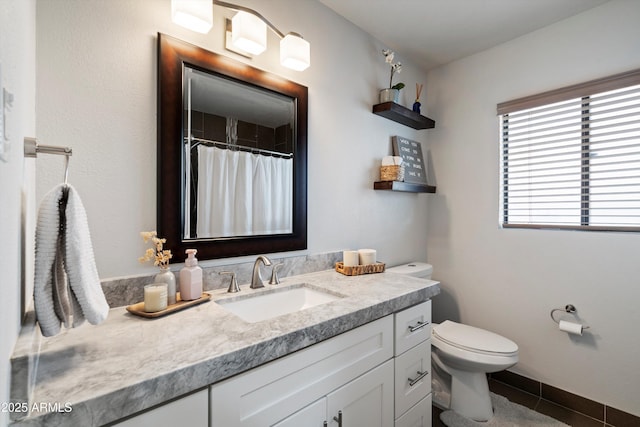 bathroom with tile patterned flooring, vanity, and toilet