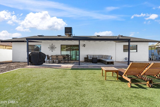 rear view of house with a patio area, an outdoor living space, and a yard