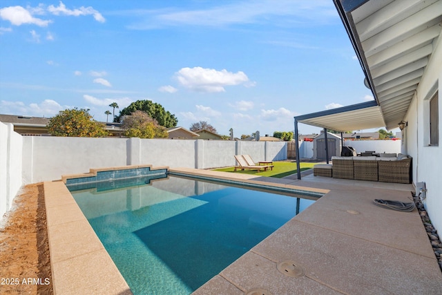 view of swimming pool with a patio area, a storage shed, and an outdoor hangout area