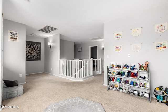 playroom with carpet, visible vents, and baseboards