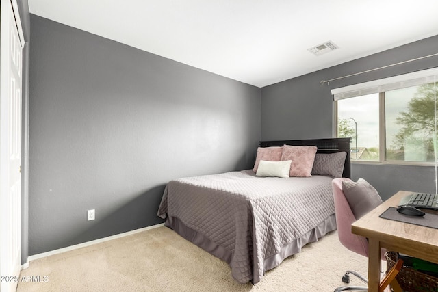 carpeted bedroom featuring visible vents and baseboards