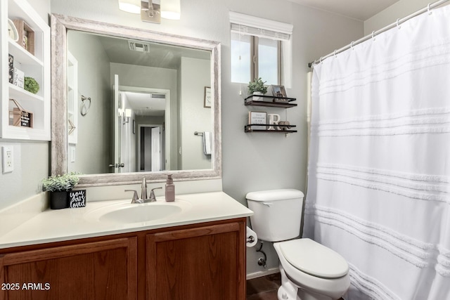 bathroom featuring toilet, visible vents, and vanity