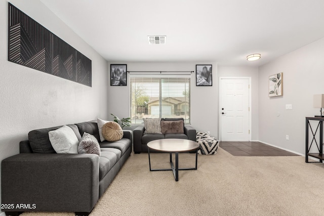 carpeted living area with baseboards and visible vents