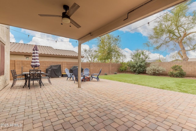 view of patio with a fenced backyard, a ceiling fan, and area for grilling