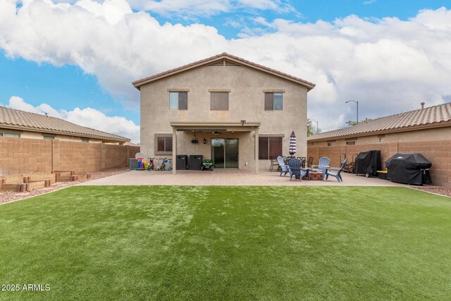 back of property featuring a fenced backyard, a patio, a lawn, and stucco siding