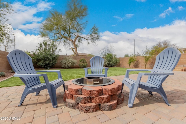 view of patio / terrace with a fenced backyard and a fire pit