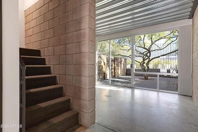 doorway to outside with concrete floors