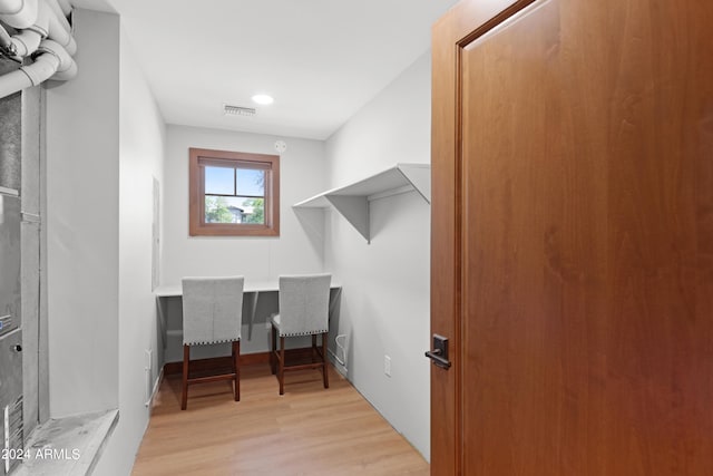 laundry area featuring light wood-type flooring