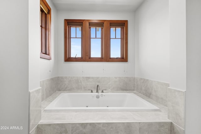 bathroom featuring tiled tub