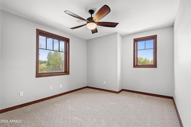 empty room with ceiling fan and carpet floors