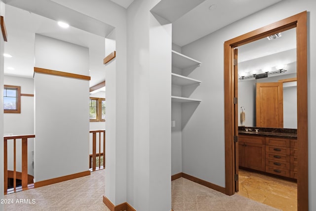 spacious closet featuring sink