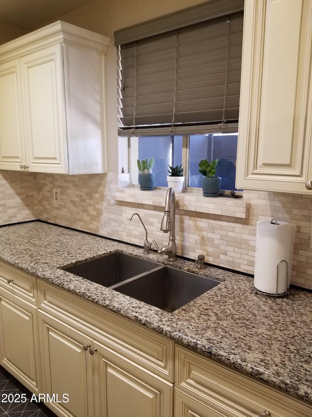 6011 N 33rd Ave, Phoenix, AZ 85017 - kitchen with a sink, tasteful backsplash, light stone countertops, and cream cabinetry
