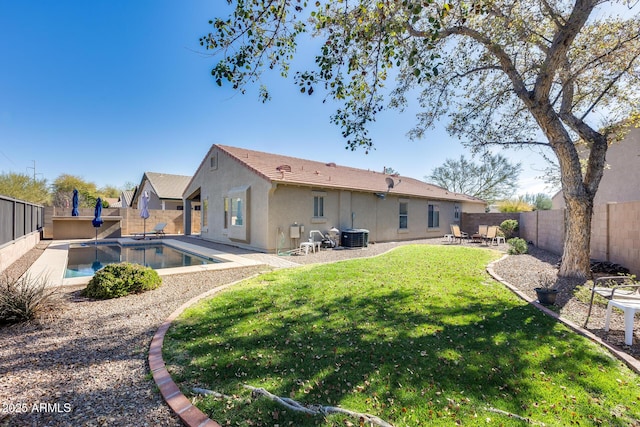 back of house with a fenced in pool, a yard, a patio, stucco siding, and a fenced backyard