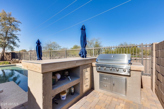 view of patio with an outdoor kitchen, a grill, a fenced in pool, and fence