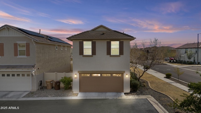 front facade with a garage and solar panels