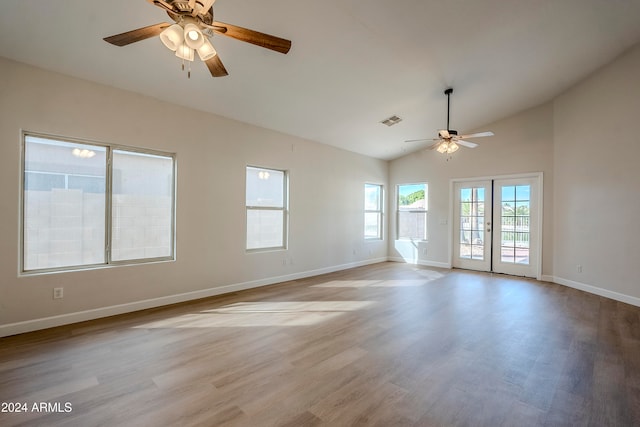 unfurnished room with french doors, light wood-type flooring, vaulted ceiling, and ceiling fan