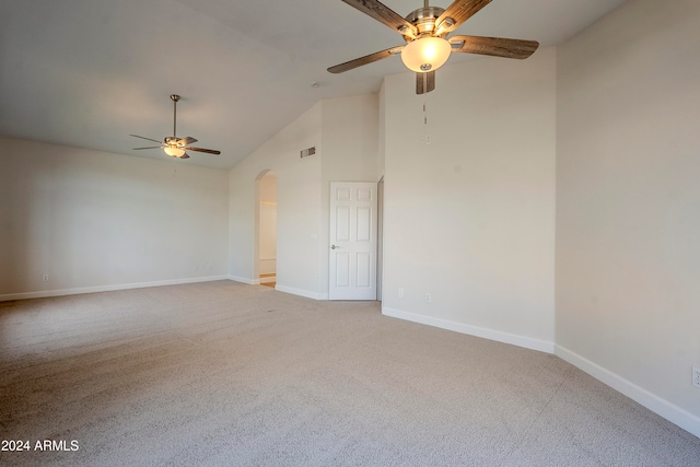 carpeted spare room with ceiling fan and lofted ceiling