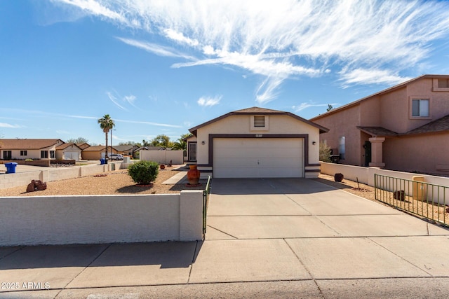 view of front facade featuring a fenced front yard, a garage, driveway, a residential view, and stucco siding