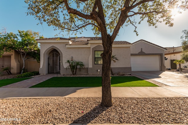 mediterranean / spanish-style home with a garage