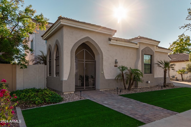 mediterranean / spanish-style home with a front yard