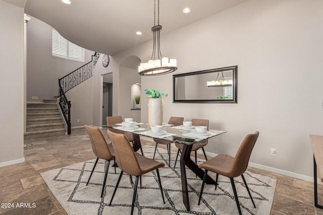 dining space featuring high vaulted ceiling