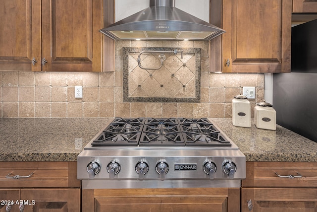 kitchen with backsplash, stone countertops, wall chimney range hood, and stainless steel gas stovetop