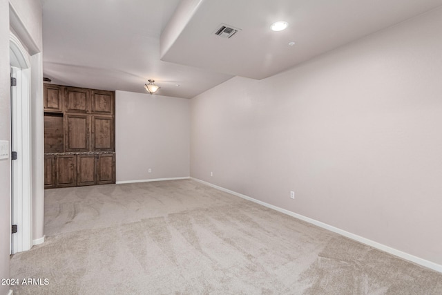 empty room featuring light carpet