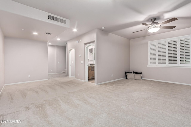 interior space featuring ceiling fan and light carpet