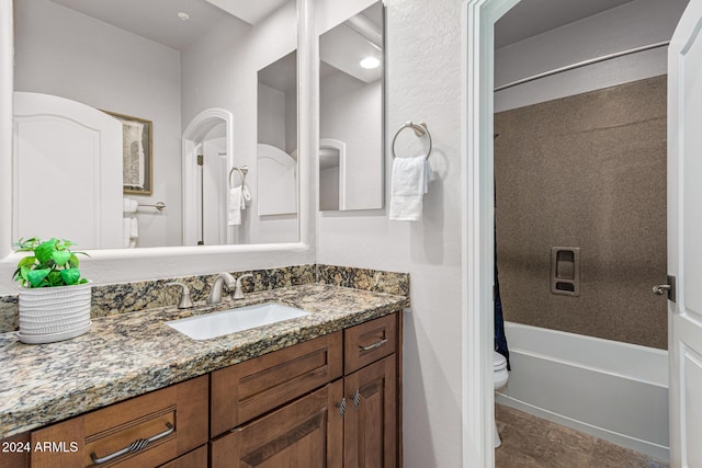 full bathroom featuring shower / bath combination with curtain, toilet, and vanity