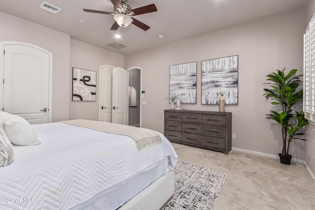 bedroom featuring ceiling fan and light carpet