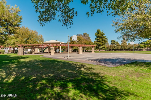 view of community with a lawn, basketball court, and a pergola