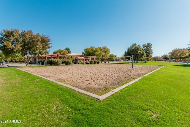 view of property's community featuring a yard and volleyball court