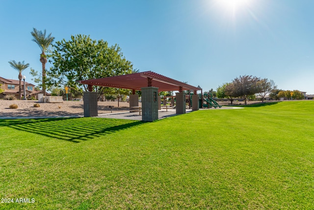 surrounding community featuring a playground and a lawn